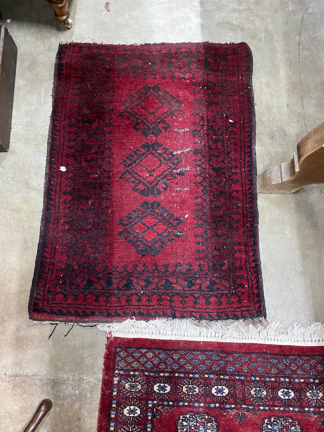 A Bokhara red ground runner and an Afghan rug, larger 250cms x 80cms.